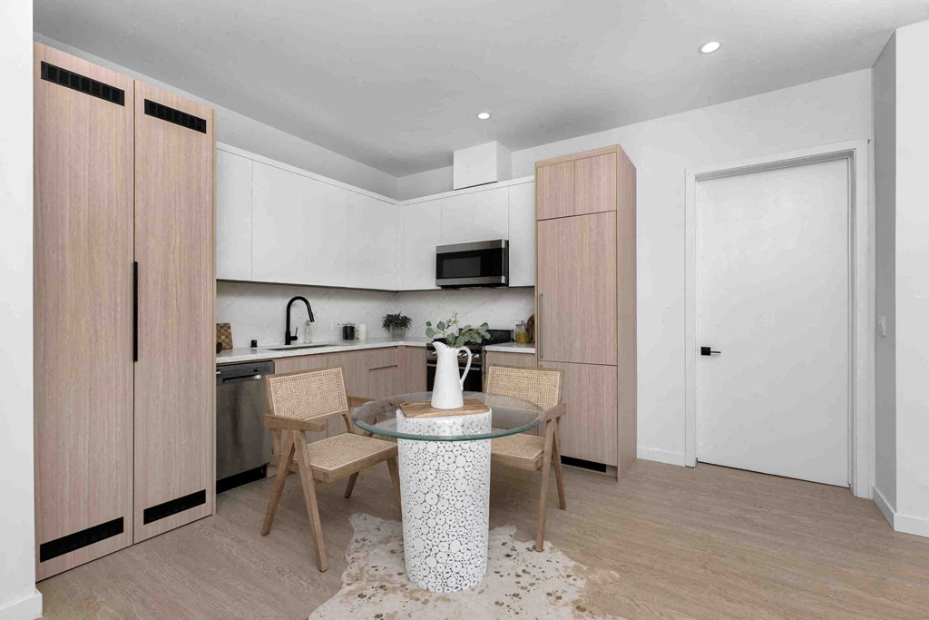 a kitchen and dining room with a table and chairs