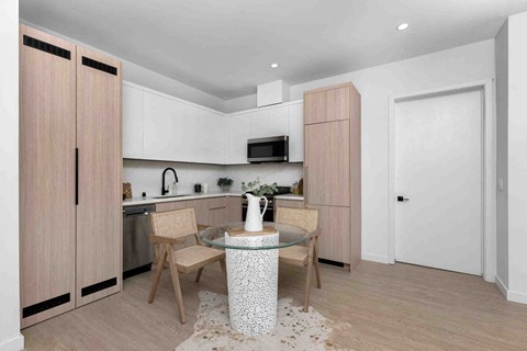 a kitchen and dining room with a table and chairs