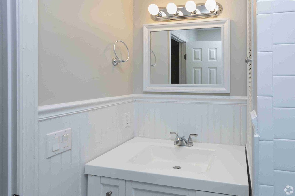 a small bathroom with a sink and a mirror