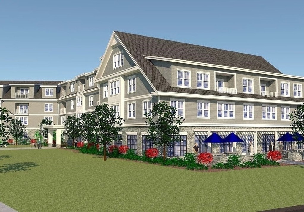 a rendering of a large apartment building with a lawn