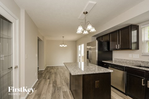 a kitchen with a granite counter top and black appliances