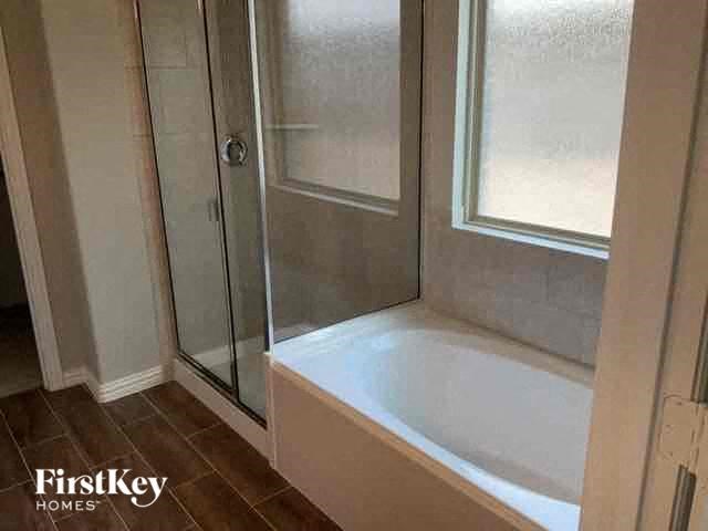 a bathroom with a bath tub and a shower