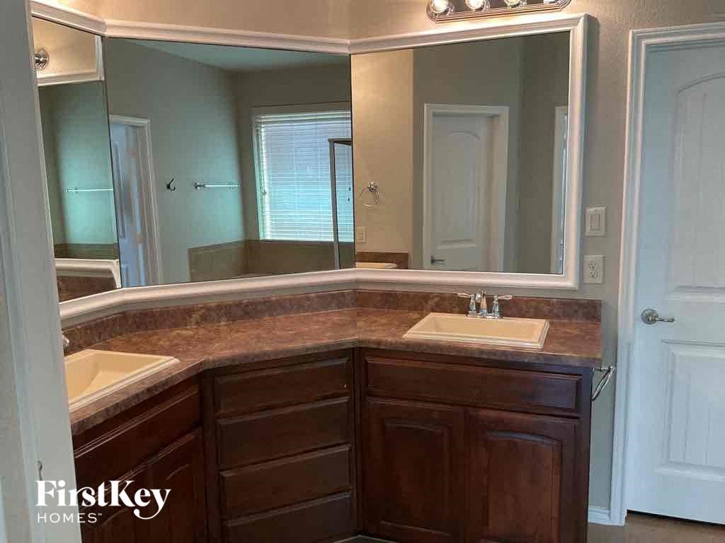 a bathroom with two sinks and a large mirror