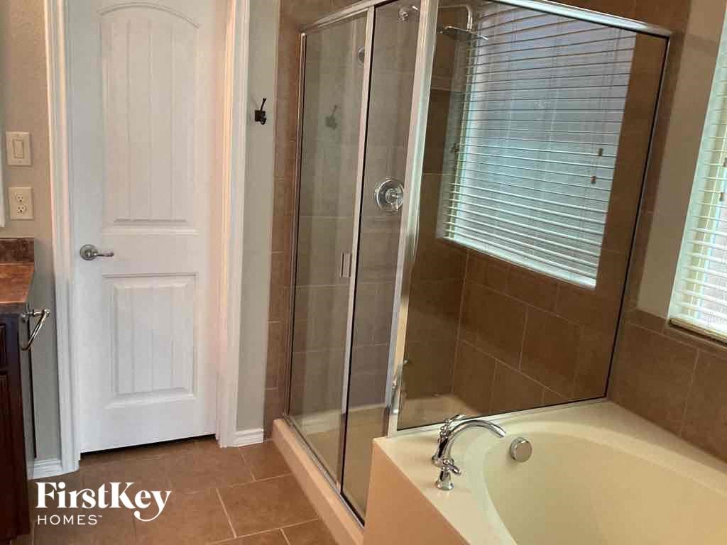 a small bathroom with a shower and a tub