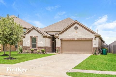 a white brick house with a garage door