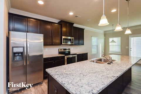 a kitchen with granite counter tops and stainless steel appliances