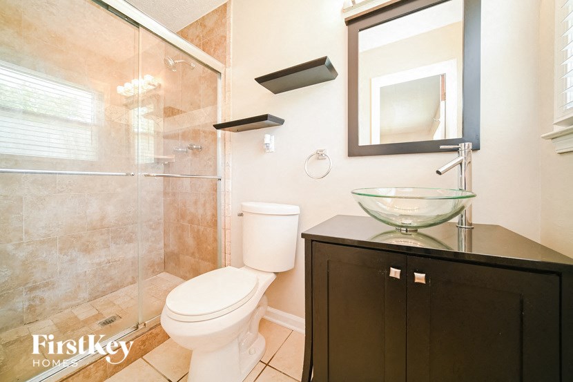 a bathroom with a toilet and a sink and a shower