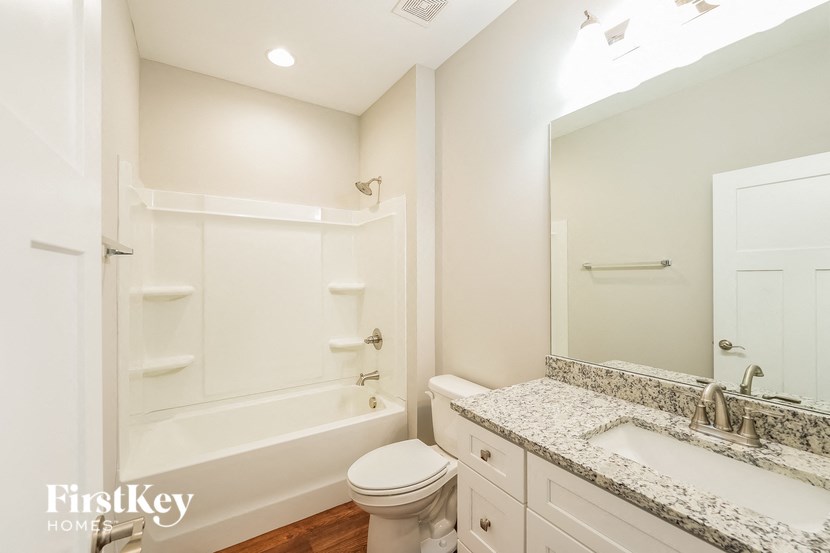 a bathroom with a sink toilet and a bath tub