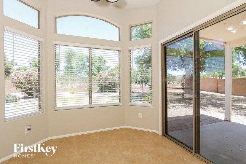 a living room with large windows and a sliding glass door