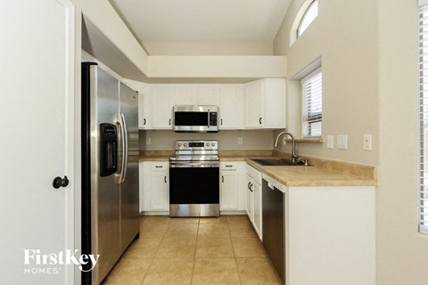 a kitchen with stainless steel appliances and white cabinets