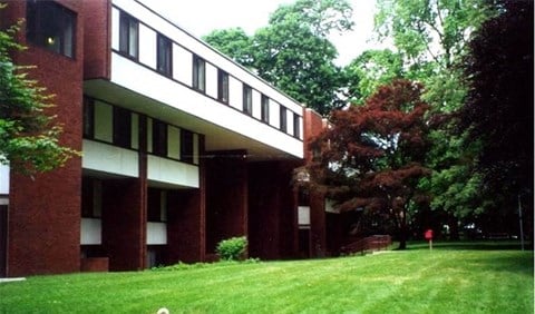 a large building with a lawn in front of it