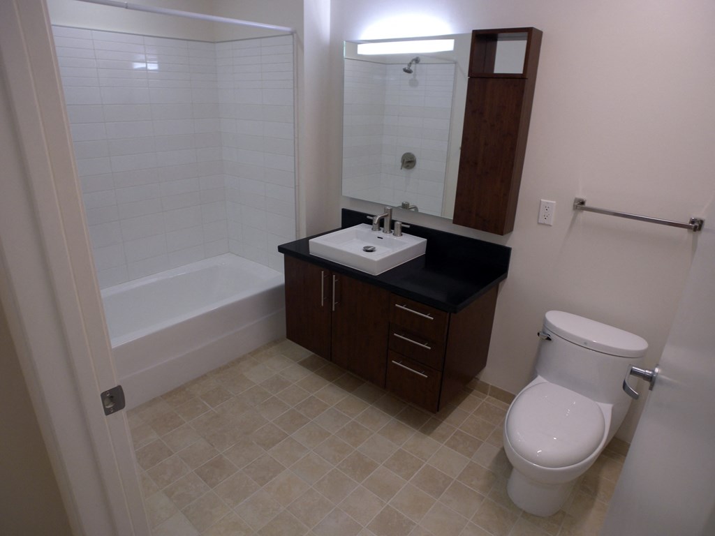 a bathroom with a toilet and a sink and a bath tub