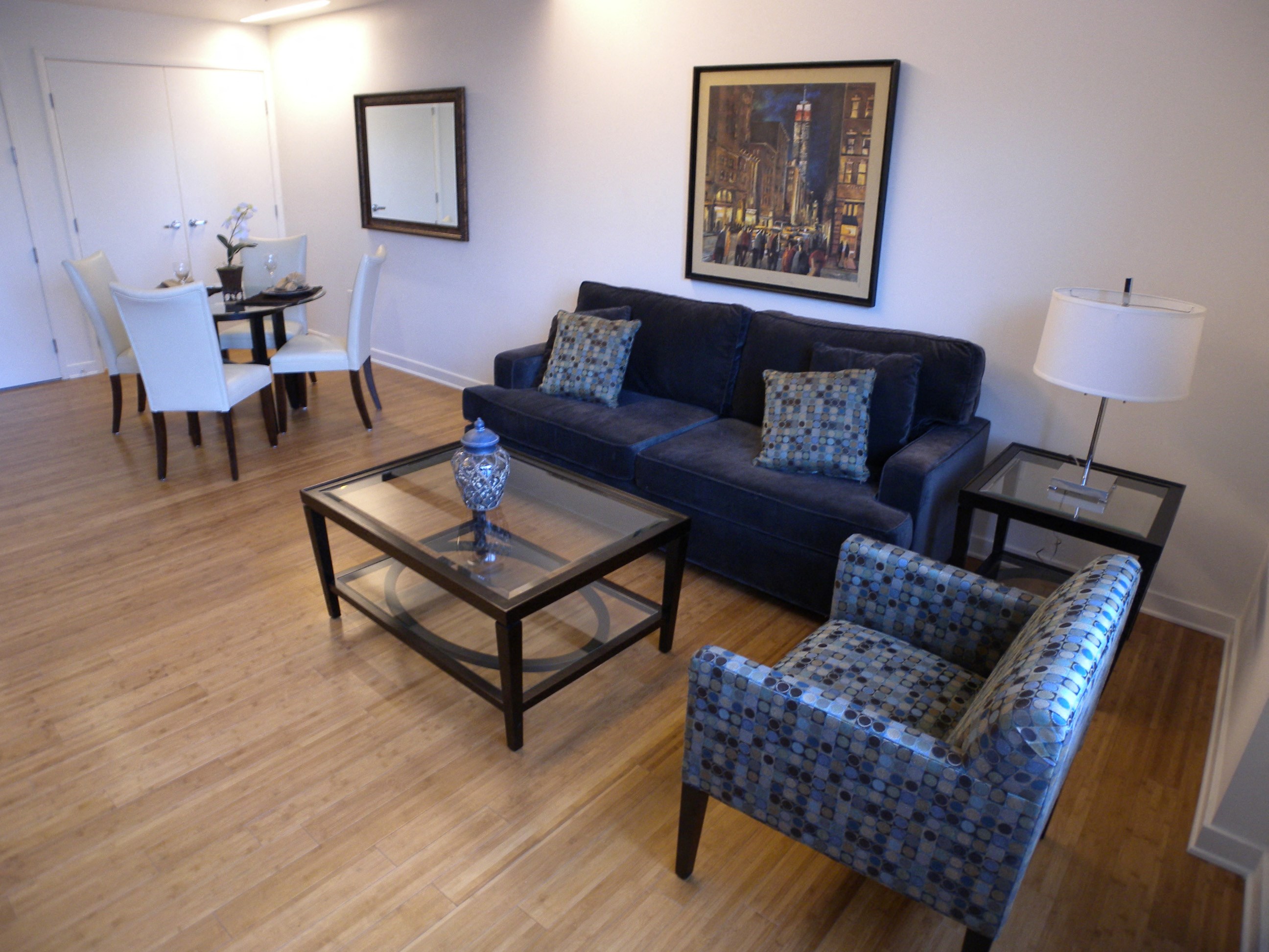 a living room with a couch and chairs and a table