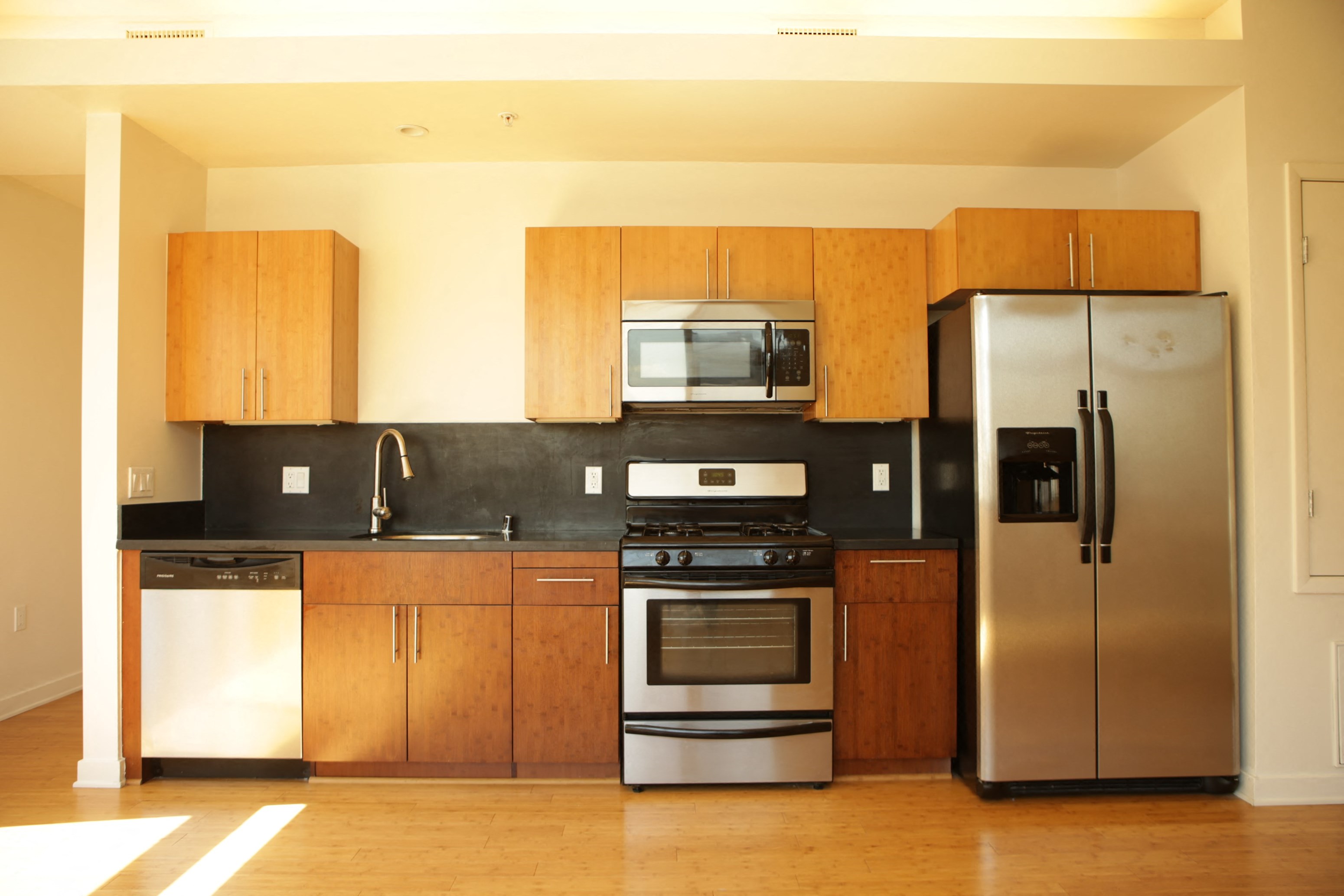 a kitchen with stainless steel appliances and wooden cabinets