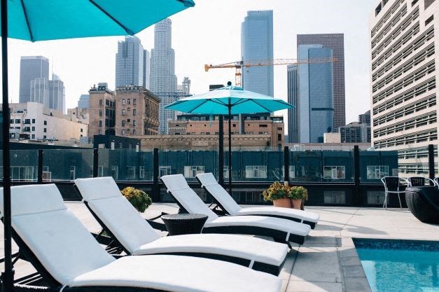 a group of lounge chairs sitting next to a swimming pool