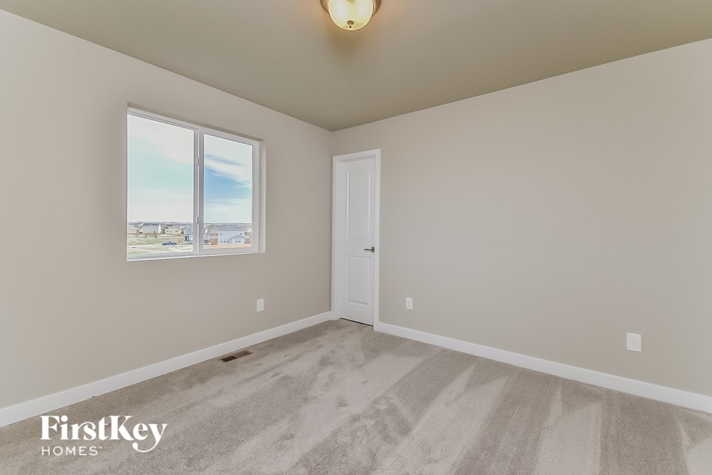 an empty room with a door and a window