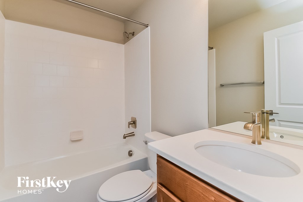 a bathroom with a sink and a toilet and a tub