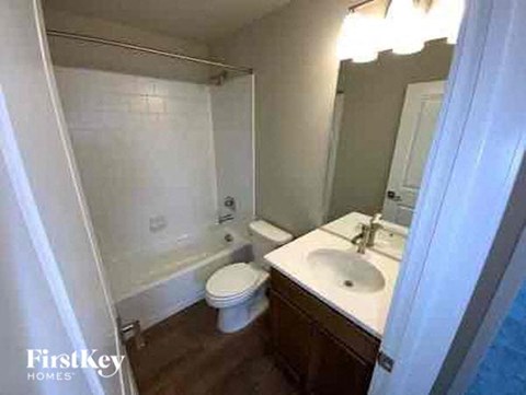 a bathroom with a toilet and a sink and a shower