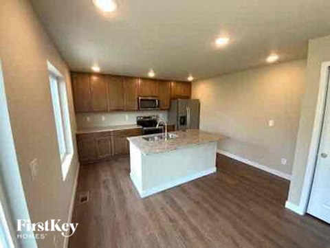 a large kitchen with a white counter top