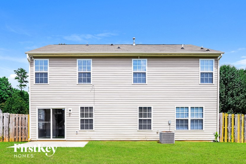 a white house with a yard in front of it