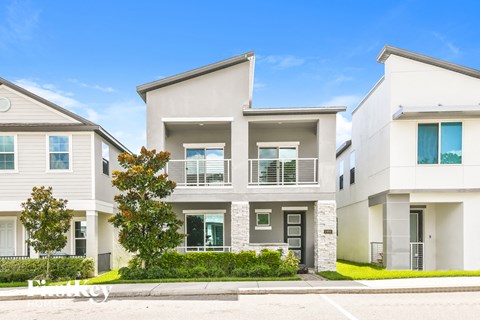 a white house with a sidewalk in front of it