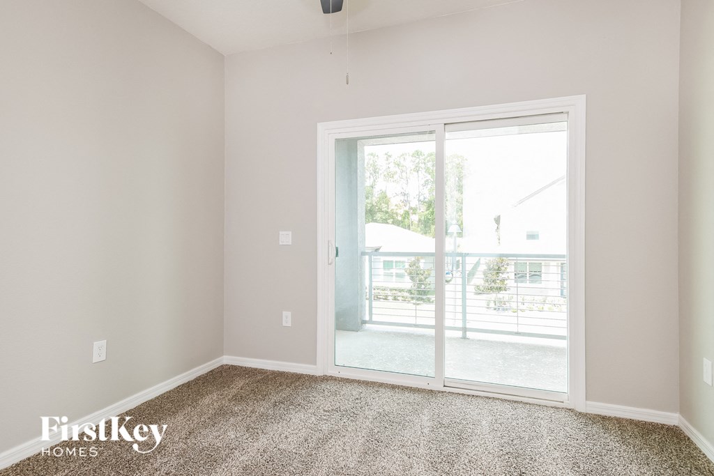 a living room with glass doors to a balcony