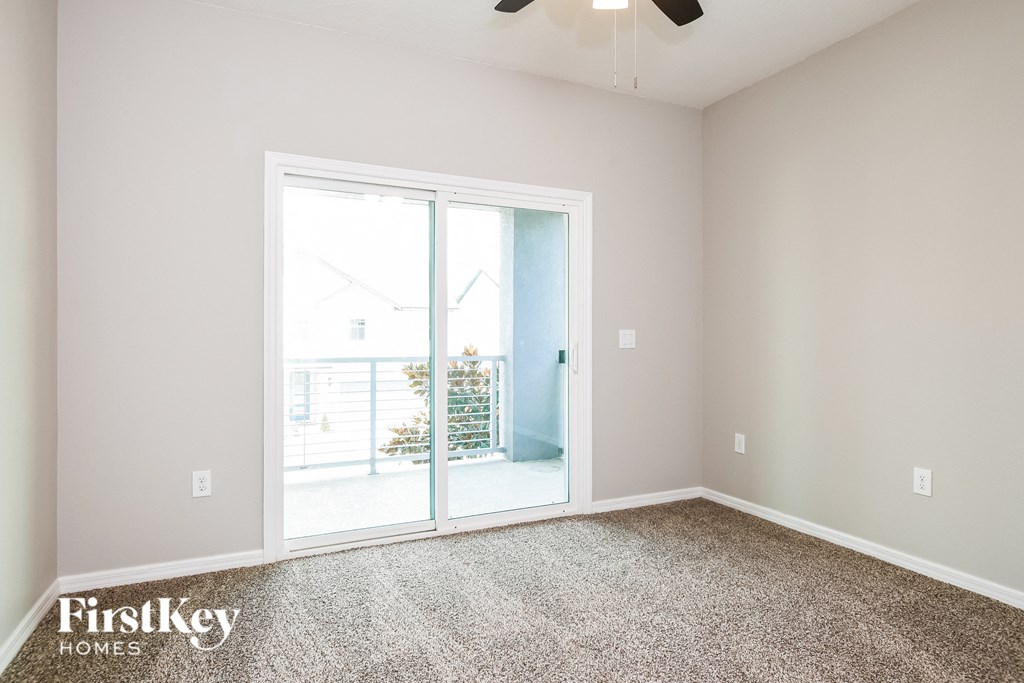 the living room of an empty house with a patio door