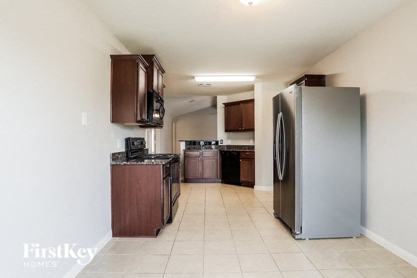 a kitchen with stainless steel appliances and wooden cabinets