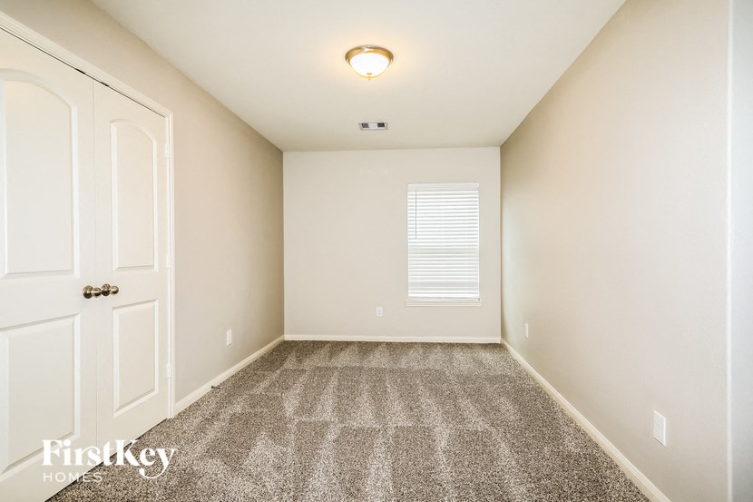a empty room with carpet and a white door