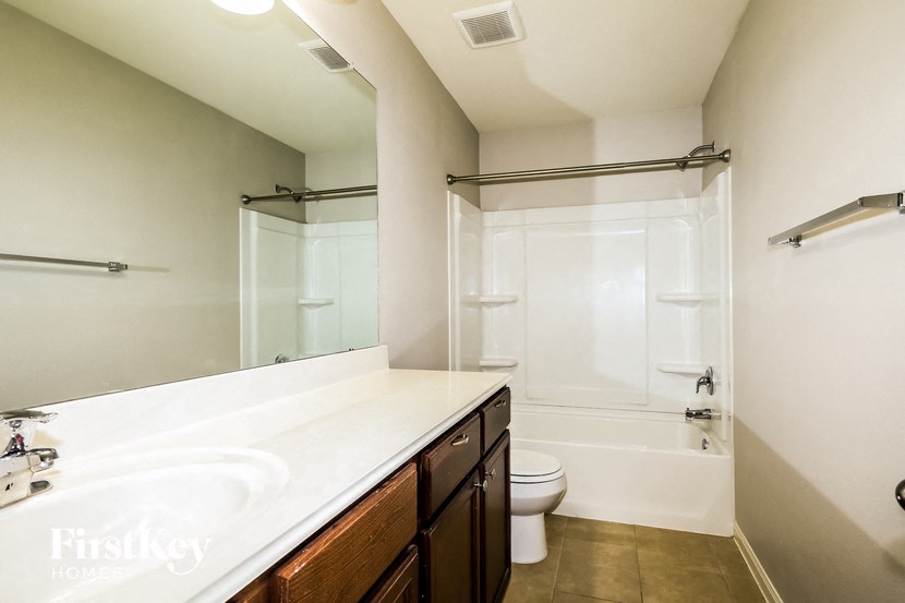 a bathroom with a sink and a toilet and a shower