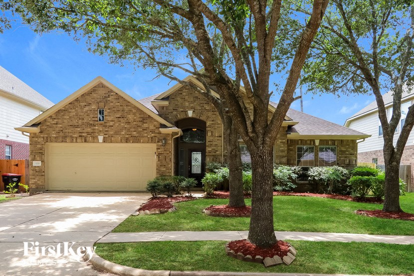 a brick house with a tree in front of it