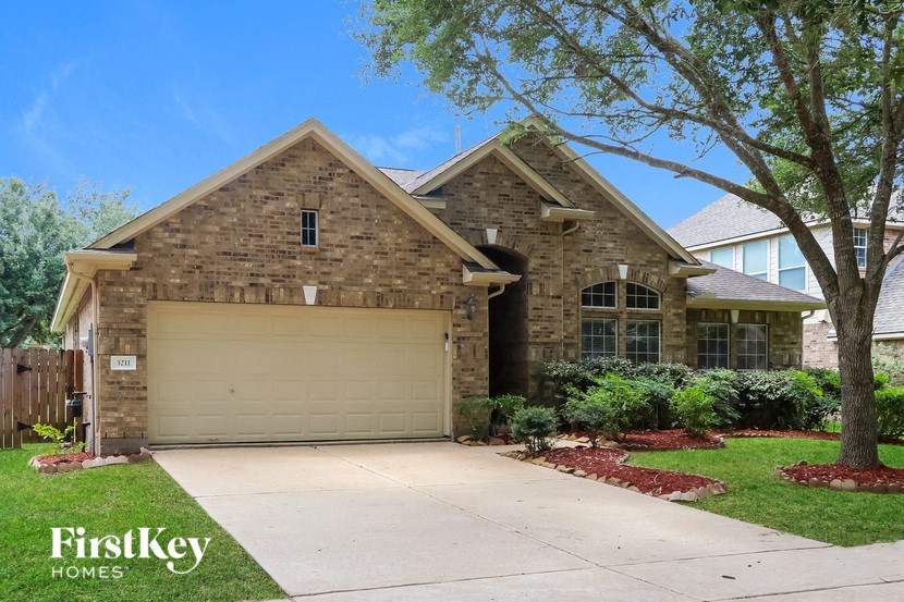 a brown brick house with a garage door