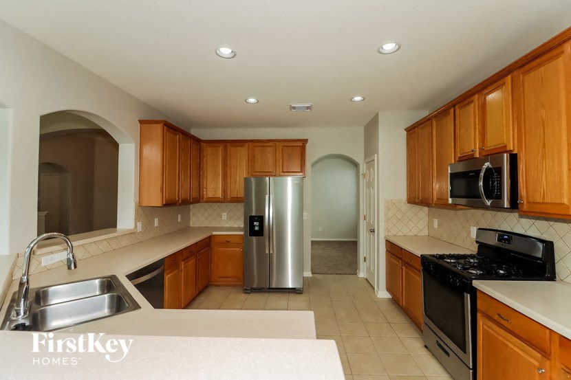 a kitchen with stainless steel appliances and wooden cabinets