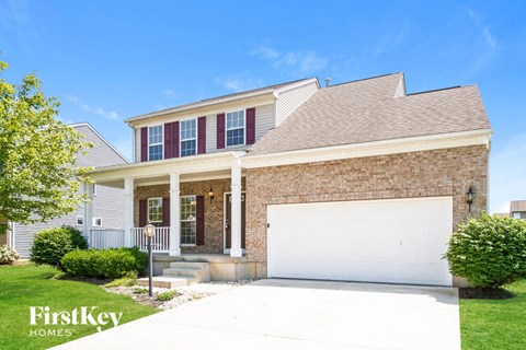 a brick house with a white garage door