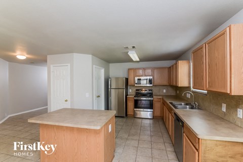 a kitchen with wooden cabinets and stainless steel appliances