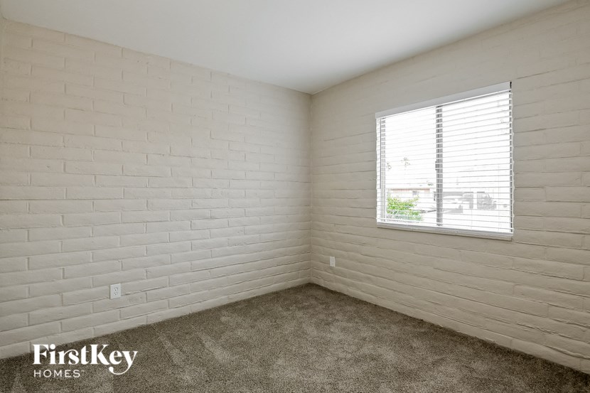 a white brick room with a window in it