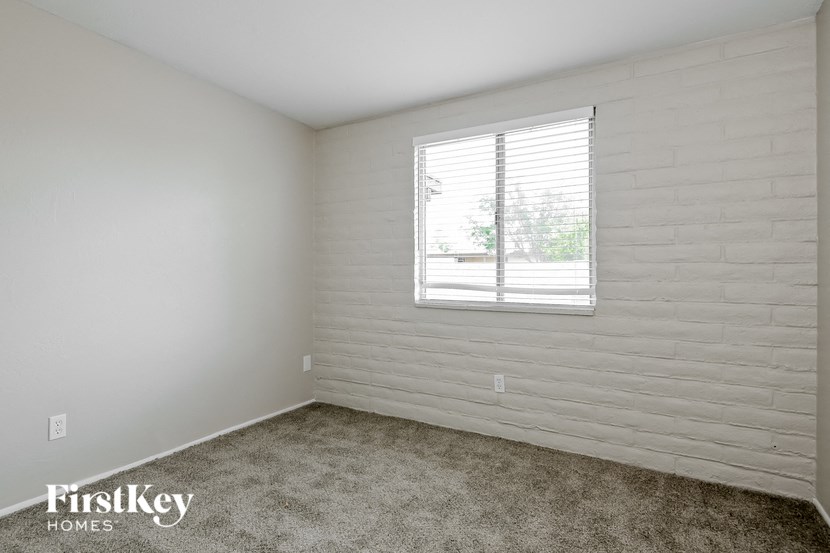 a white room with a window and carpet