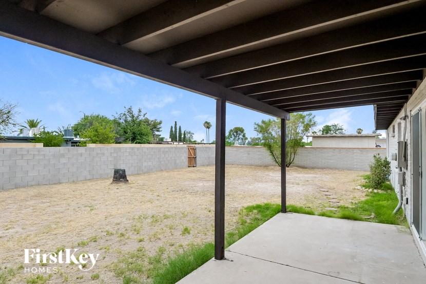 a view of the yard from under a covered patio