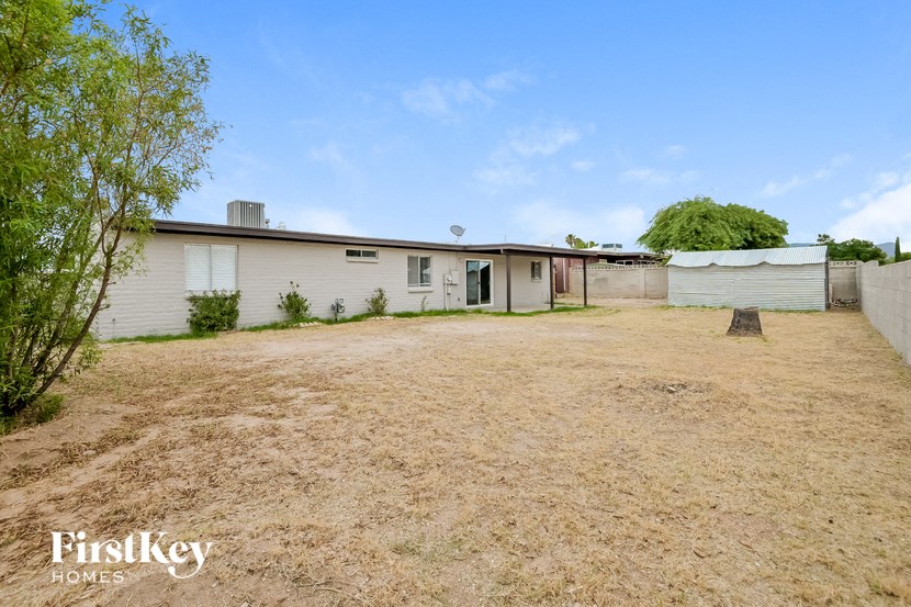 a small white house with a yard in front of it