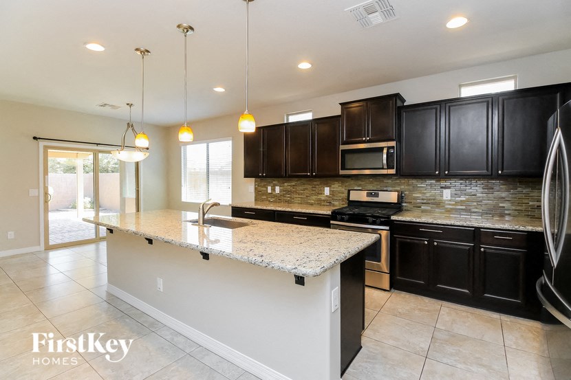 a kitchen with black cabinets and a white counter top