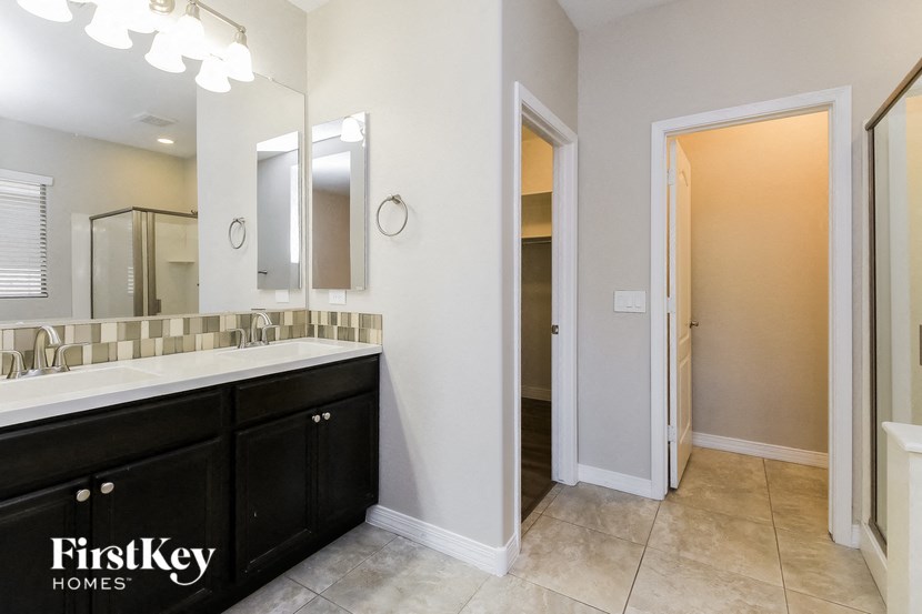 a bathroom with a large mirror and a sink