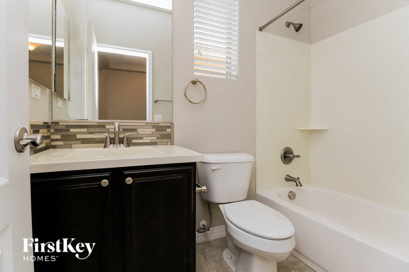 a bathroom with a sink toilet and a bath tub