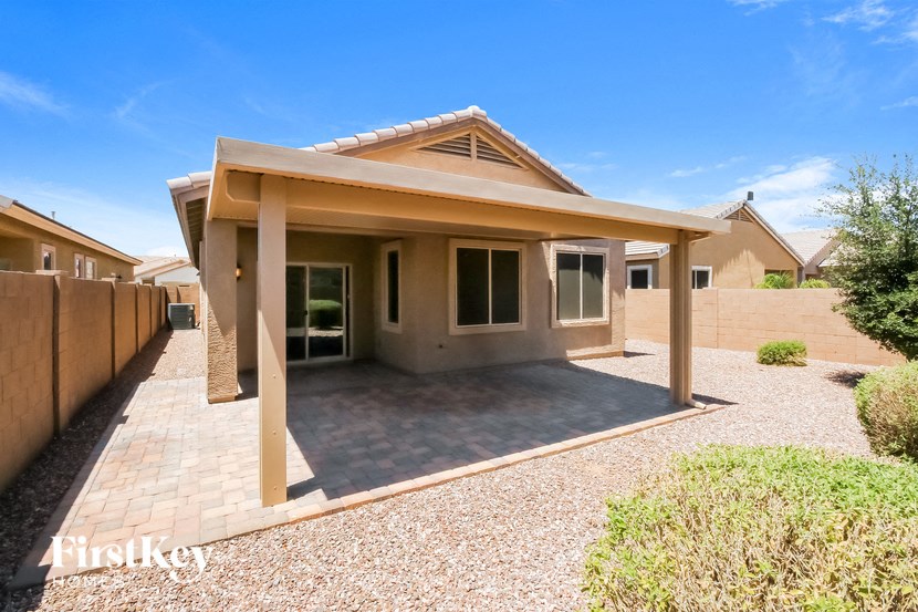a small house with a patio and a fence