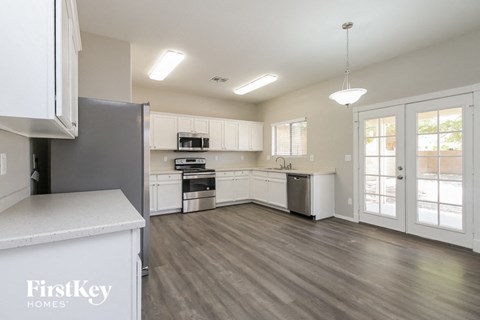 A kitchen with a refrigerator that says FirstKey Homes.