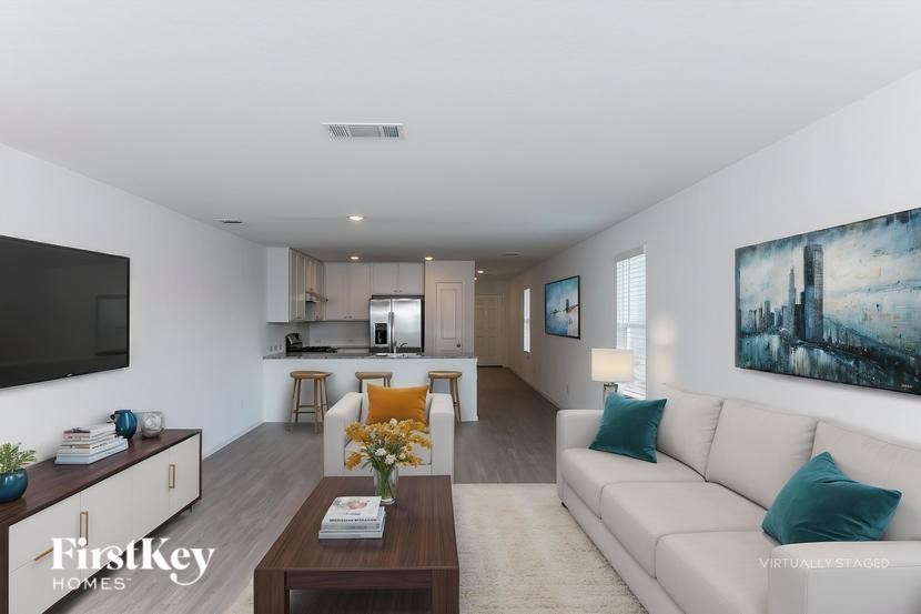 A modern living room with a white couch and a wooden coffee table.