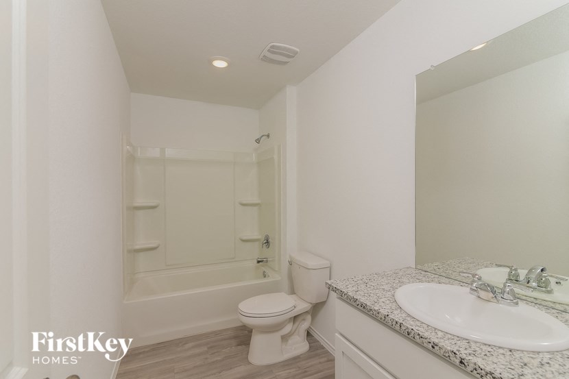 a bathroom with a sink and a toilet and a shower