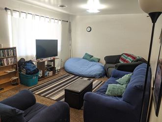 a living room filled with furniture and a tv