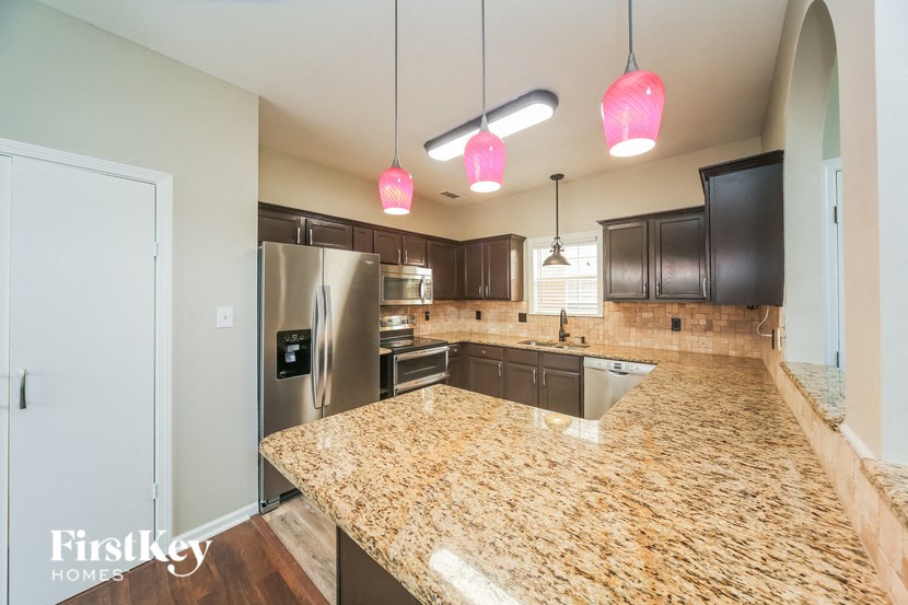 a kitchen with granite counter tops and stainless steel appliances
