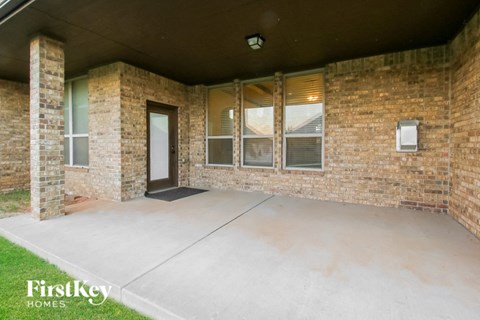 an empty porch in a brick building with a door