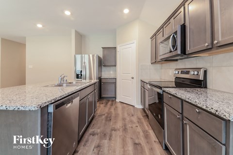 A kitchen with a FirstKey Homes logo.
